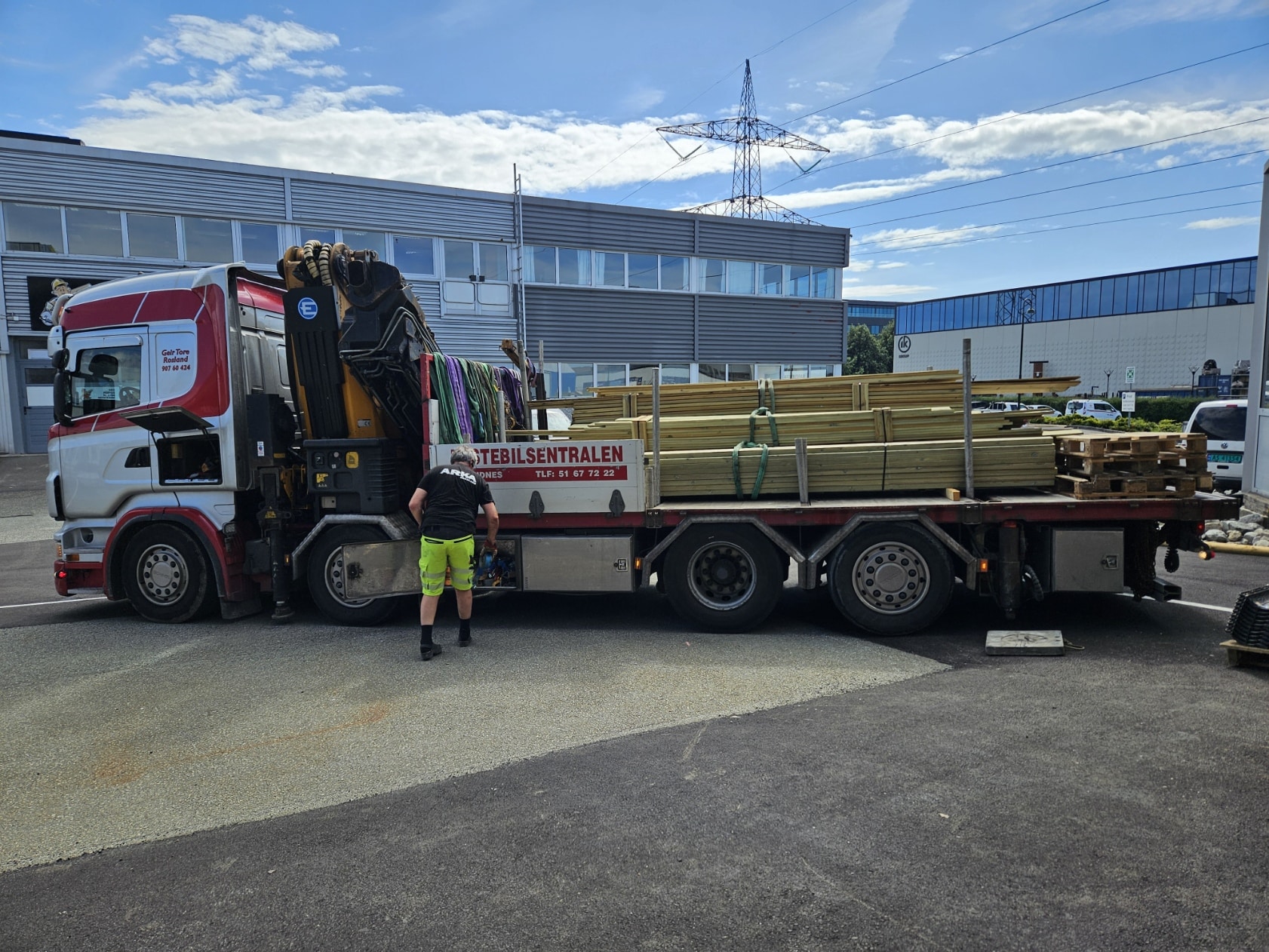 Truck unloading wooden materials at site