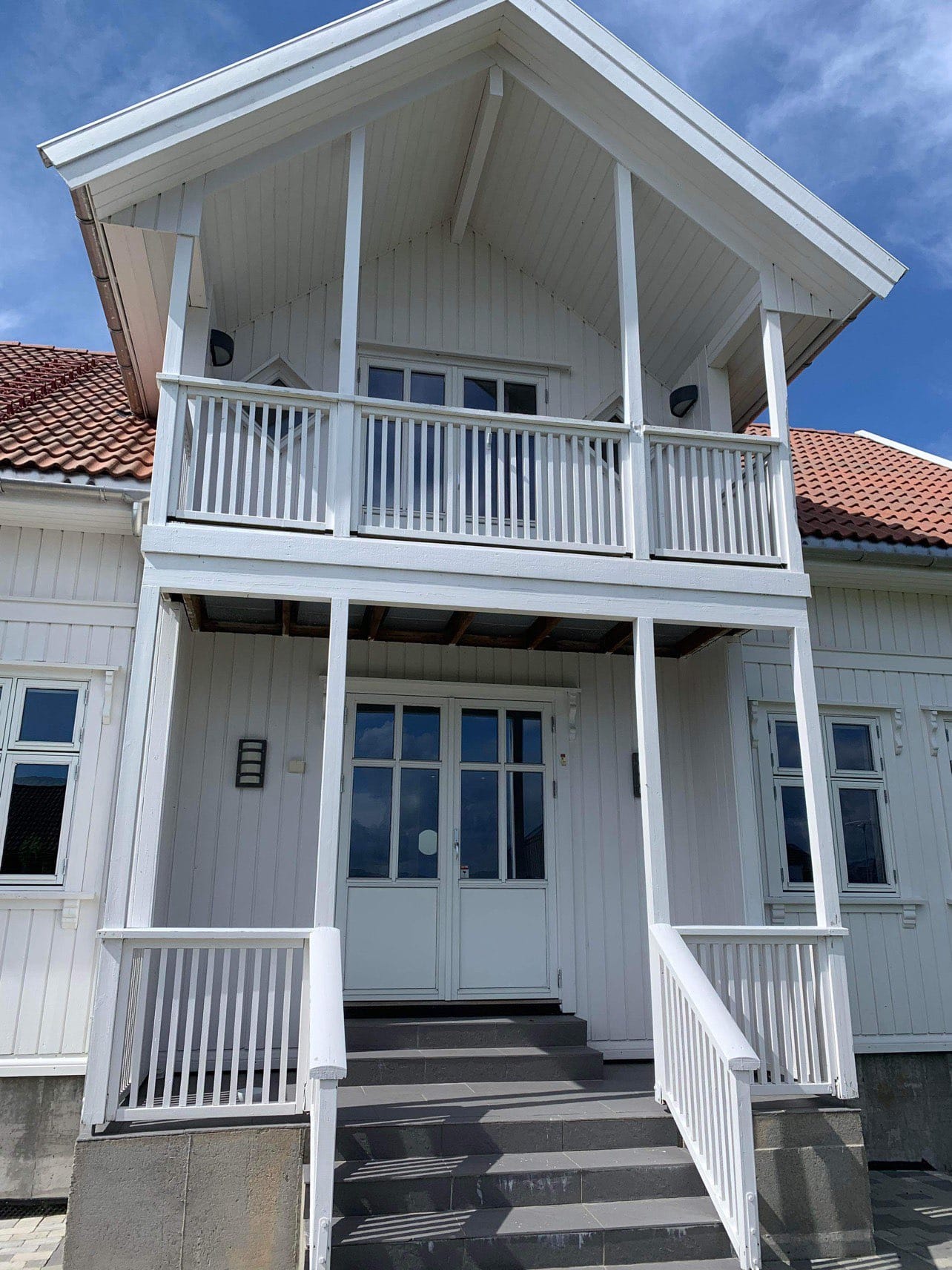 White house with balcony and stairs
