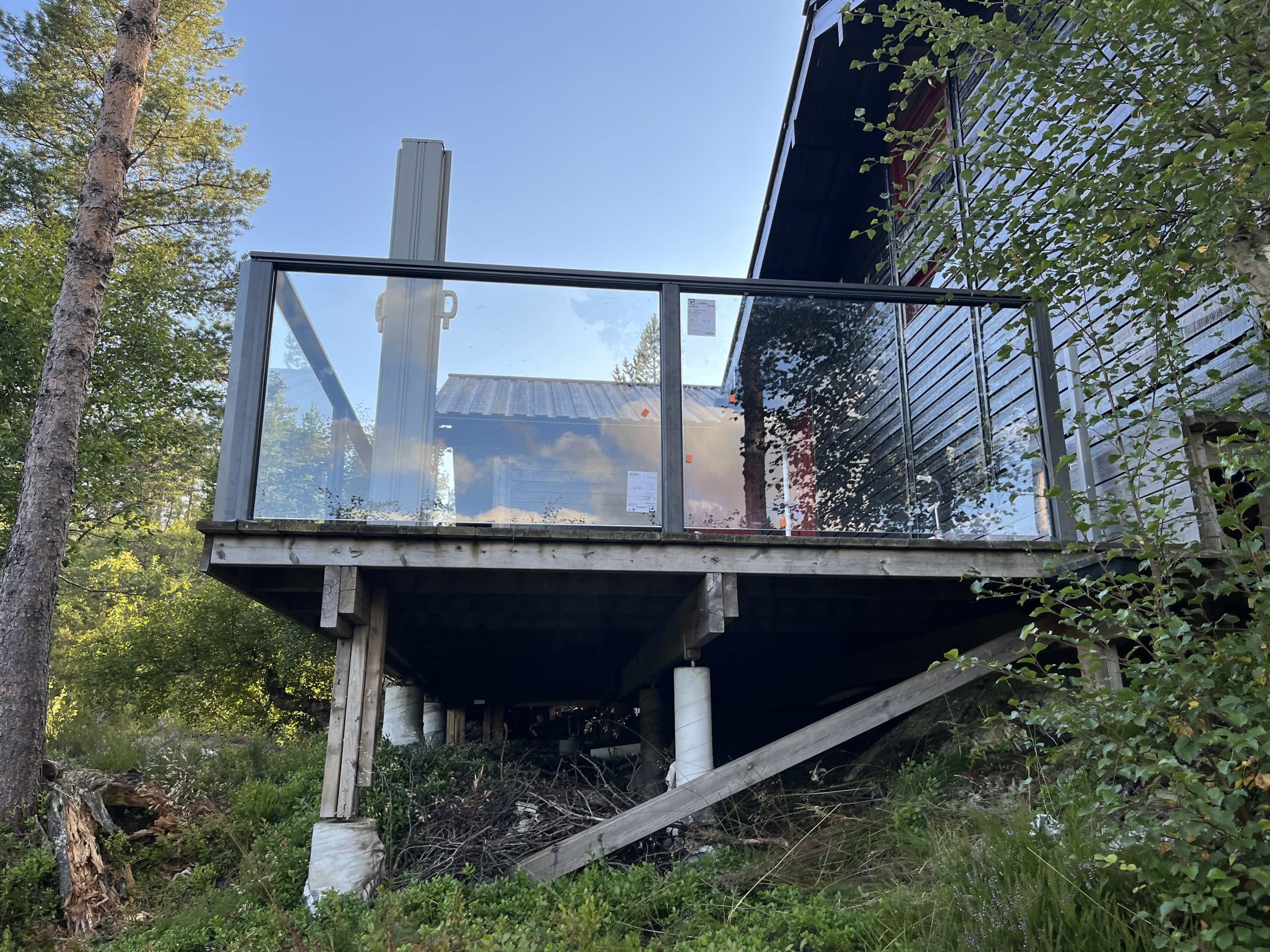 Elevated deck surrounded by greenery.