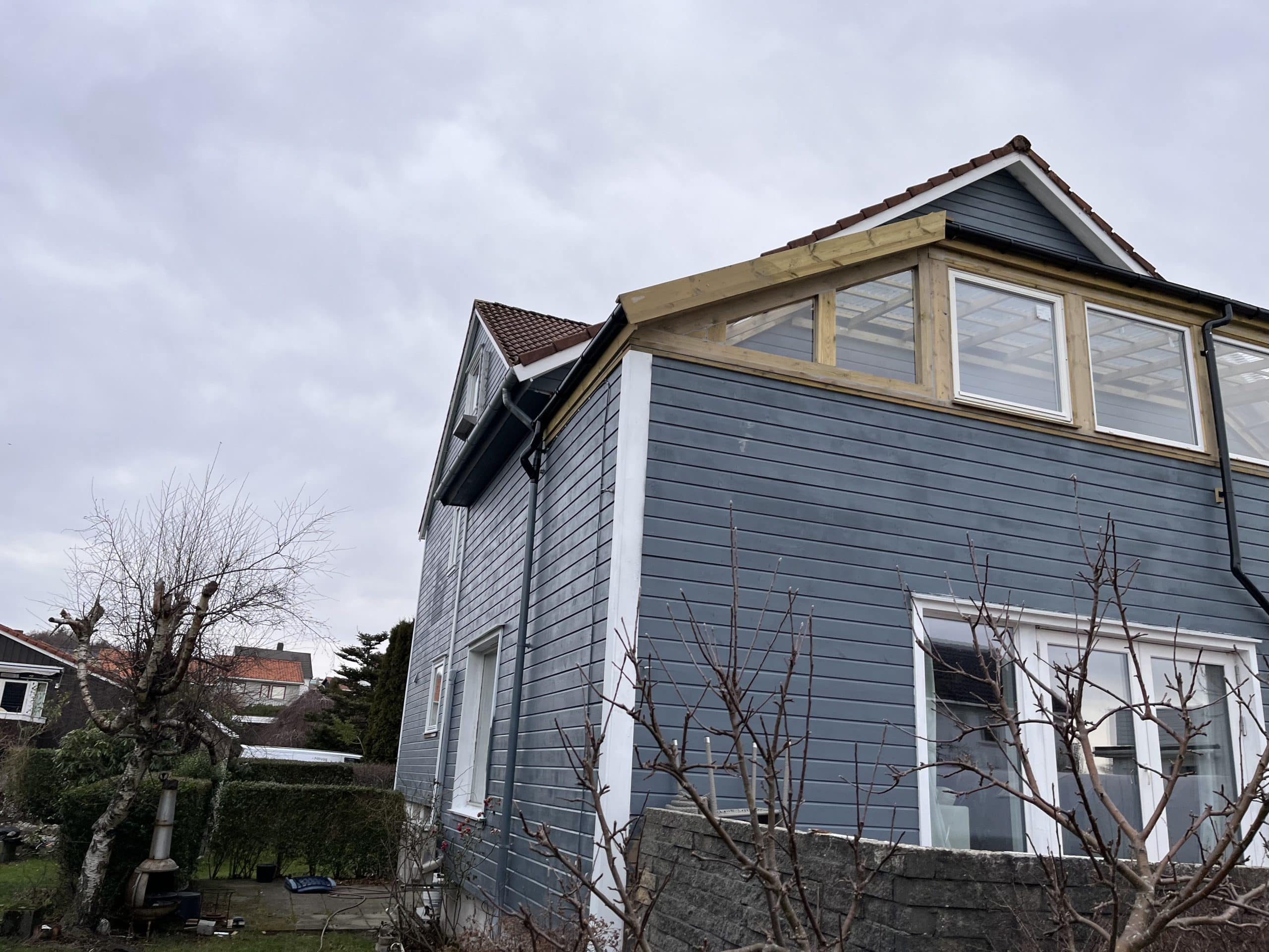 Blue house under cloudy sky