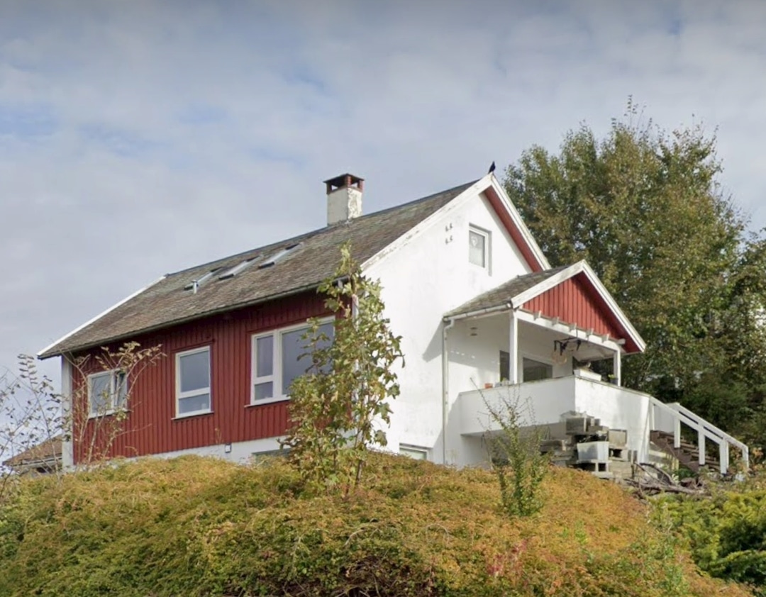 Red and white house on hillside