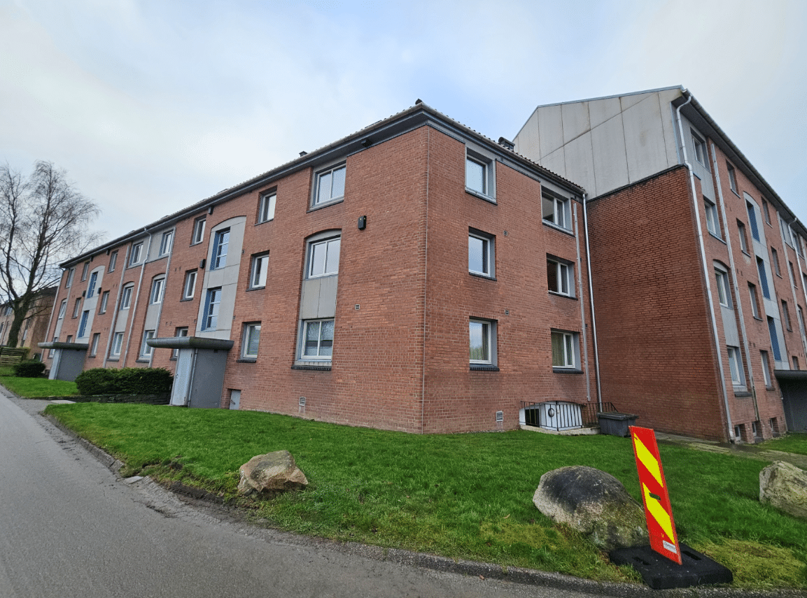 Brick apartment building with grassy area