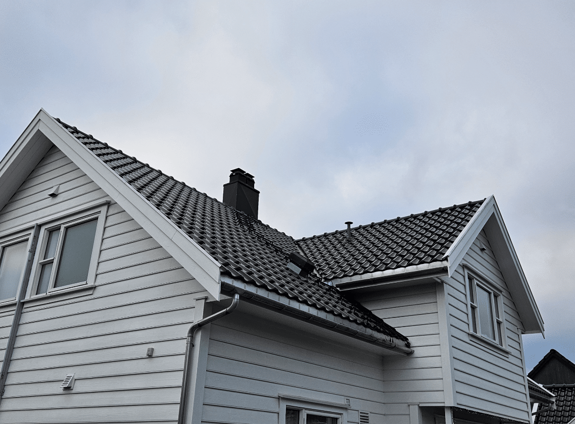 House roof under cloudy sky