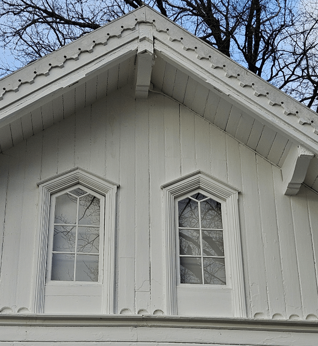 White house with decorative windows.