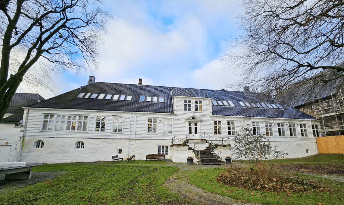 White building with trees and sky